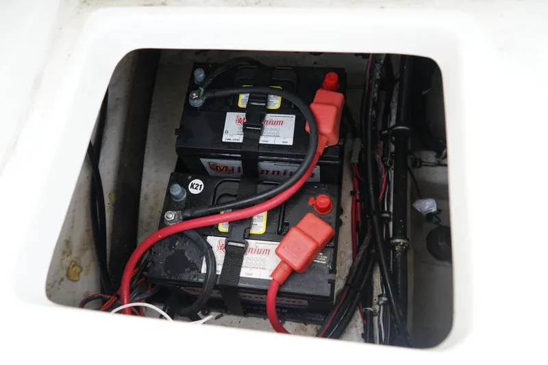 Slide: The Image of Battery compartment of 2022 Sea Hunt Ultra 229 boat with wiring and connections. - 8