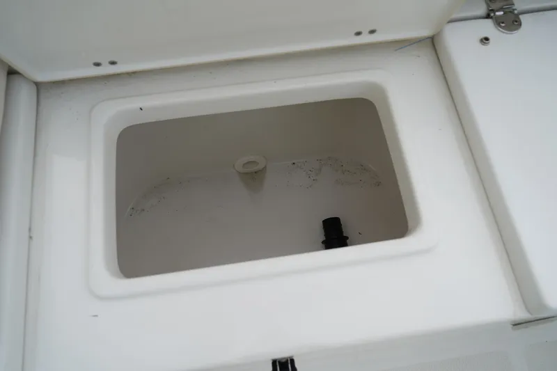 Slide: The Image of Livewell compartment on a 2022 Sea Hunt Ultra 229 boat, open and empty. - 9