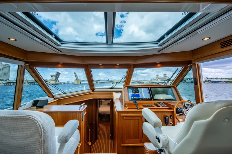 Slide: The Image of Interior view of 2022 Sabre 58 Salon Express yacht with panoramic windows and modern helm. - 10