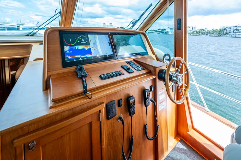 Slide: The Image of Helm of 2022 Sabre 58 Salon Express yacht with navigation equipment and steering wheel. - 11