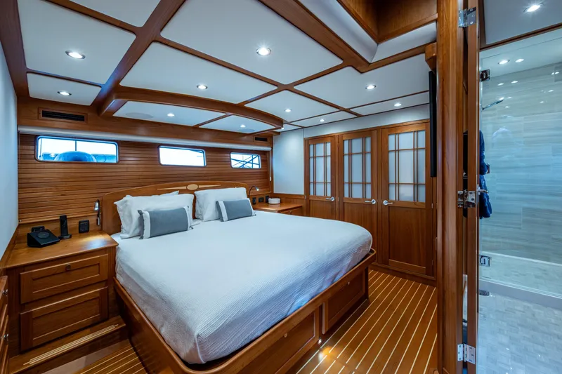 Slide: The Image of Luxurious 2022 Sabre 58 Salon Express yacht bedroom with elegant wood finish and modern amenities. - 15