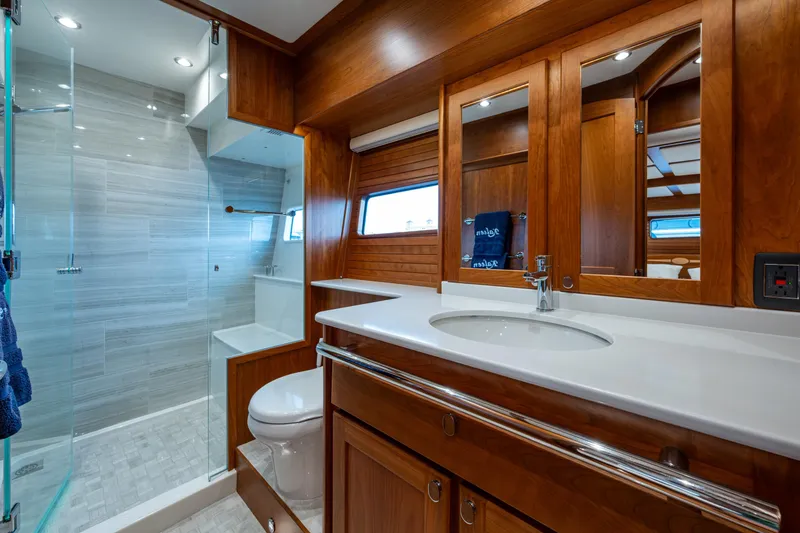 Slide: The Image of Luxurious bathroom in 2022 Sabre 58 Salon Express yacht with wood accents and modern fixtures. - 19