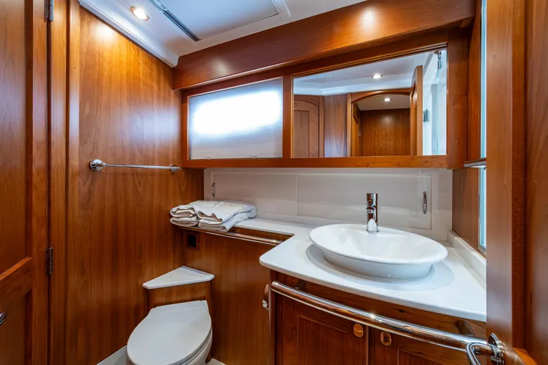 Slide: The Image of Luxurious 2022 Sabre 58 Salon Express bathroom with wood finish and modern fixtures. - 20