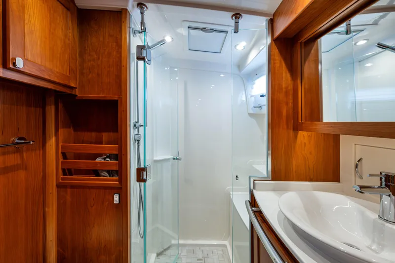Slide: The Image of Luxurious bathroom in 2022 Sabre 58 Salon Express yacht with wood accents and modern fixtures. - 24