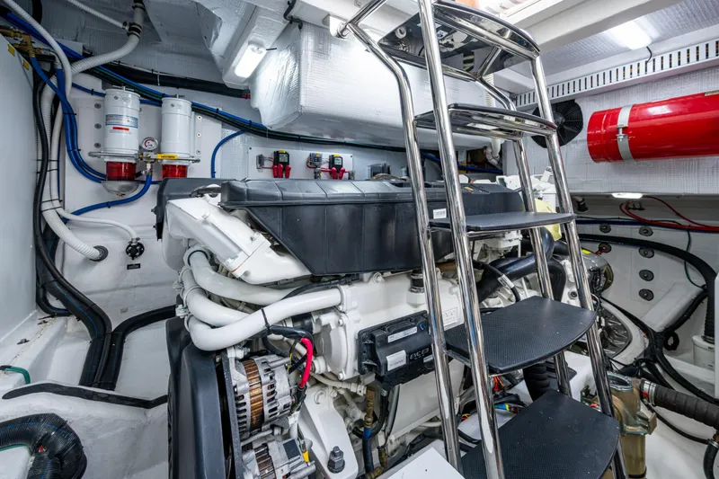 Slide: The Image of Engine room of 2022 Sabre 58 Salon Express yacht, featuring modern equipment and ladder access. - 34