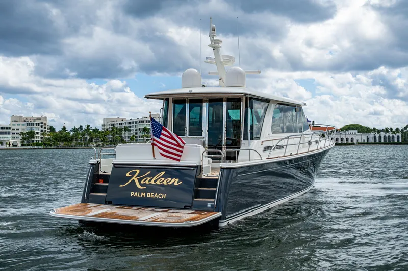Slide: The Image of 2022 Sabre 58 Salon Express yacht cruising near Palm Beach with American flag. - 40