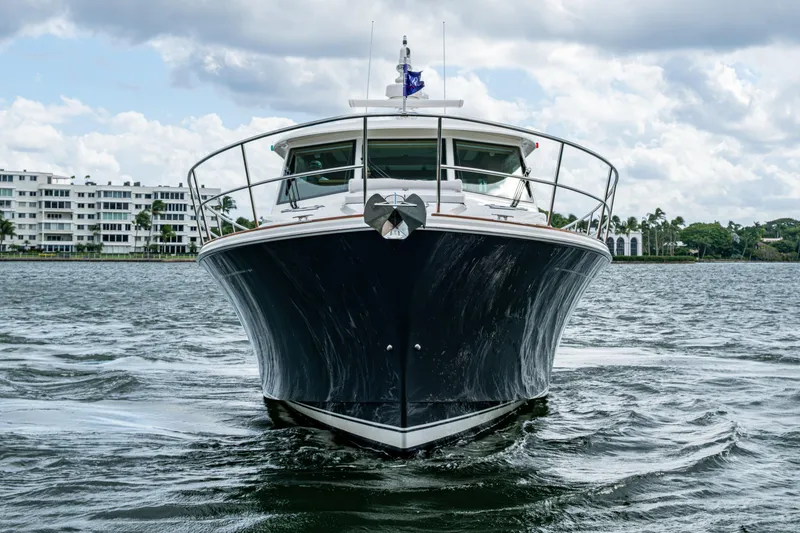 Slide: The Image of 2022 Sabre 58 Salon Express yacht cruising on a scenic waterway. - 44