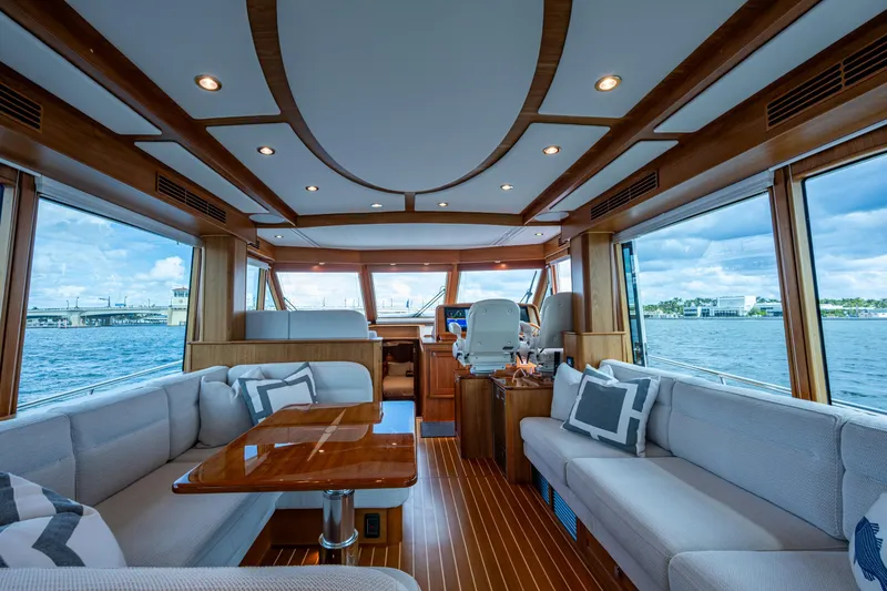 Slide: The Image of Luxurious interior of 2022 Sabre 58 Salon Express yacht with panoramic windows and elegant seating. - 7