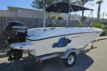 Slide: The Image of 2019 Bayliner Element E18 boat with Mercury engine, parked on trailer, side view. - 0