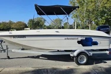 Slide: The Image of 2019 Bayliner Element E18 boat on trailer with canopy, parked outdoors. - 3