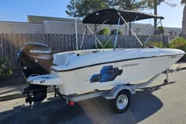 Slide: The Image of 2019 Bayliner Element E18 boat with Mercury engine on trailer, parked outdoors. - 4