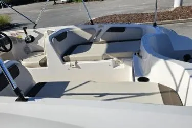 Slide: The Image of 2019 Bayliner Element E18 boat interior with seating and steering wheel. - 5