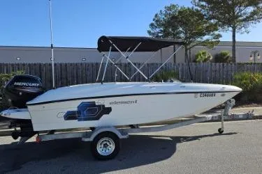 Slide: The Image of 2019 Bayliner Element E18 boat on trailer with canopy, parked outdoors. - 6