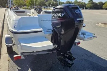 Slide: The Image of 2019 Bayliner Element E18 boat with Mercury 115 outboard motor in a parking lot. - 7