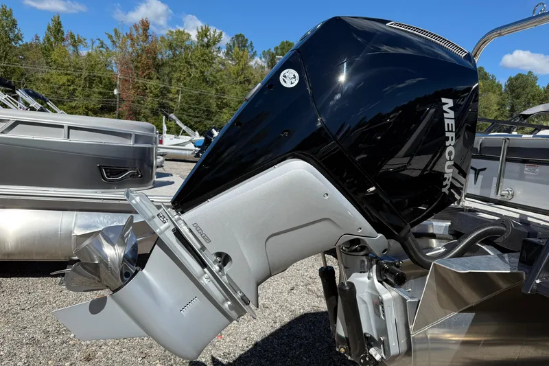 Slide: The Image of 2026 Tahoe Pontoon LTZ Entertainer with Mercury outboard motor in a marina setting. - 16