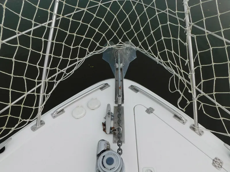 Slide: The Image of Bow of 2003 Carver 444 Cockpit Motor Yacht with anchor and safety netting. - 10