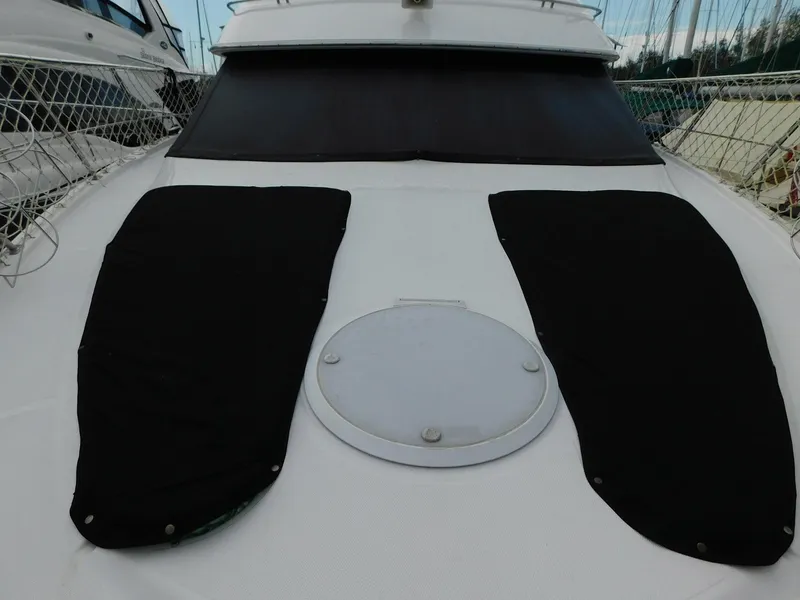 Slide: The Image of 2003 Carver 444 Cockpit Motor Yacht deck with black covers and hatch. - 11