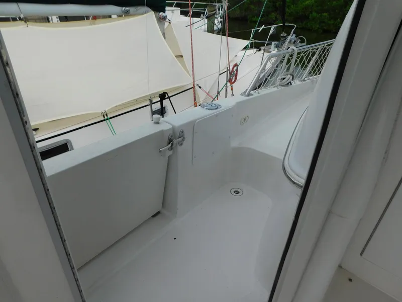 Slide: The Image of 2003 Carver 444 Cockpit Motor Yacht deck area with railing and canopy. - 16