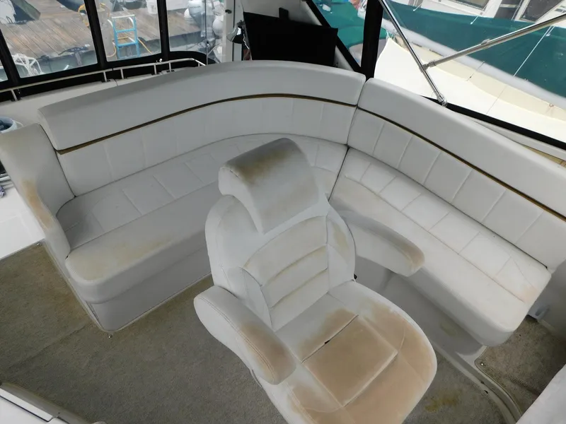 Slide: The Image of 2003 Carver 444 Cockpit Motor Yacht interior with white seating and helm chair. - 18