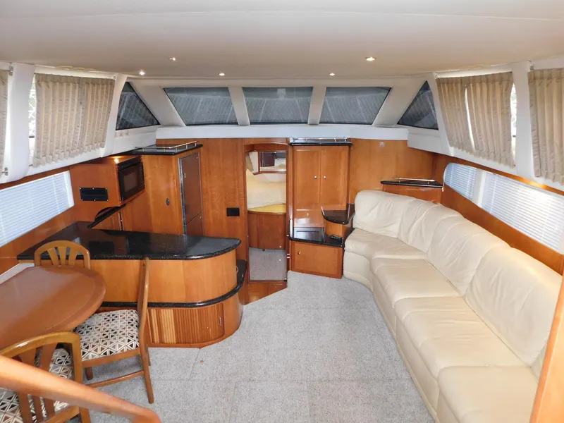 Slide: The Image of Luxurious interior of 2003 Carver 444 Cockpit Motor Yacht with plush seating and modern amenities. - 19