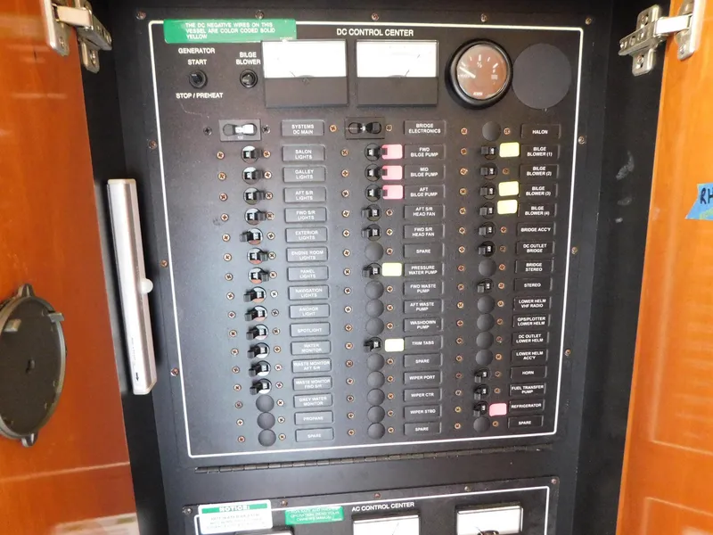 Slide: The Image of Control panel of a 2003 Carver 444 Cockpit Motor Yacht, featuring various switches and gauges. - 20