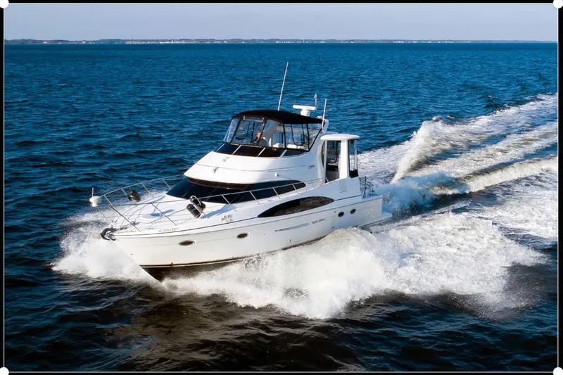 Slide: The Image of 2003 Carver 444 Cockpit Motor Yacht cruising on open water. - 3