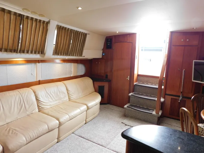 Slide: The Image of Interior of 2003 Carver 444 Cockpit Motor Yacht with beige leather seating and wooden accents. - 30