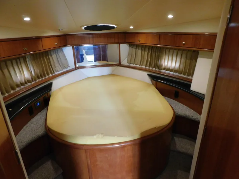 Slide: The Image of Luxurious interior of 2003 Carver 444 Cockpit Motor Yacht with spacious bed and elegant wood finish. - 34