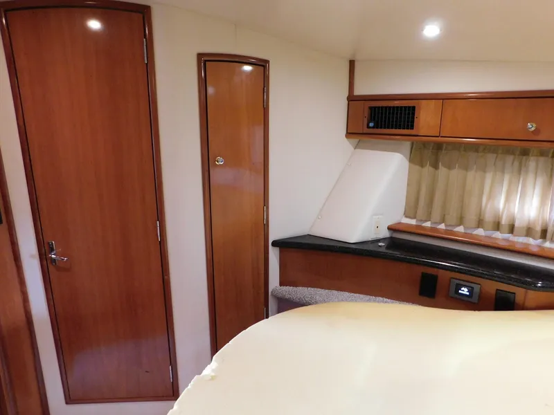 Slide: The Image of Interior of 2003 Carver 444 Cockpit Motor Yacht with wood cabinetry and cozy seating area. - 35