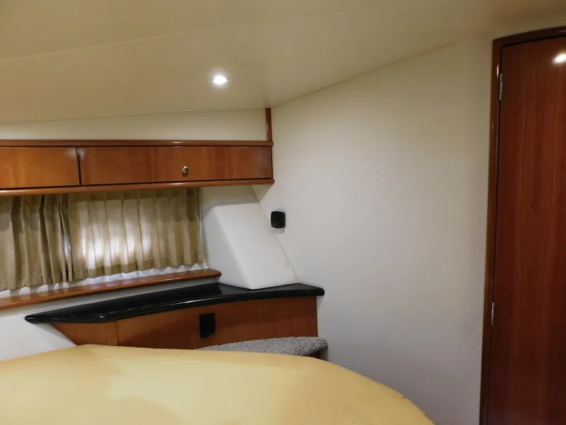 Slide: The Image of Interior of 2003 Carver 444 Cockpit Motor Yacht with wood cabinetry and soft lighting. - 36