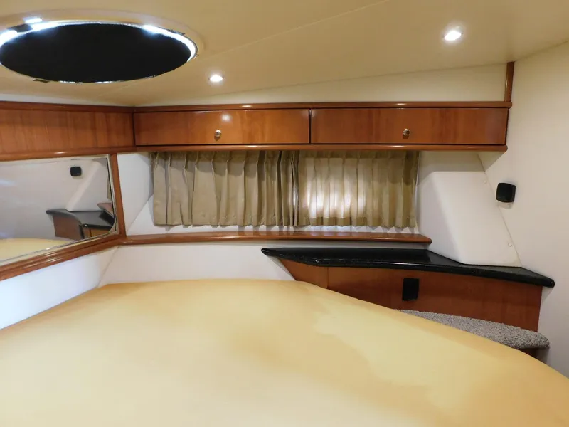 Slide: The Image of Interior of 2003 Carver 444 Cockpit Motor Yacht with wood cabinets and cozy sleeping area. - 37