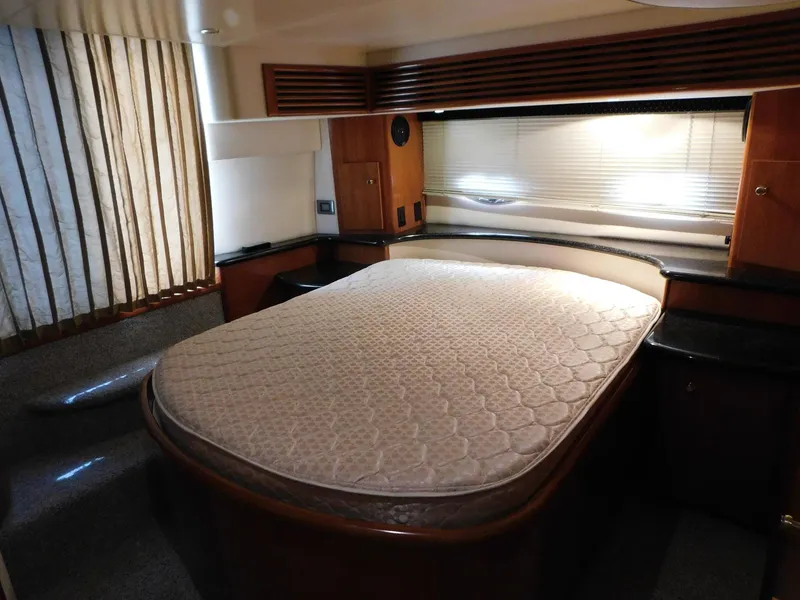 Slide: The Image of Luxurious bedroom interior of 2003 Carver 444 Cockpit Motor Yacht with elegant wood finishes. - 38