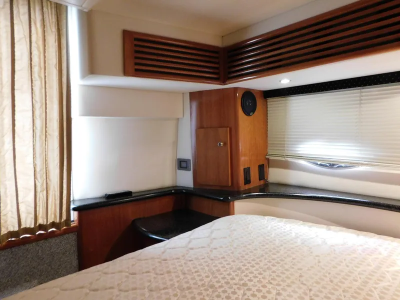 Slide: The Image of Interior of 2003 Carver 444 Cockpit Motor Yacht with wood accents and cozy bed. - 39