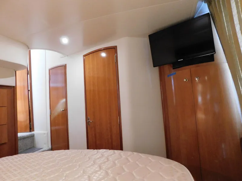 Slide: The Image of Interior of 2003 Carver 444 Cockpit Motor Yacht with wood doors and mounted TV. - 41