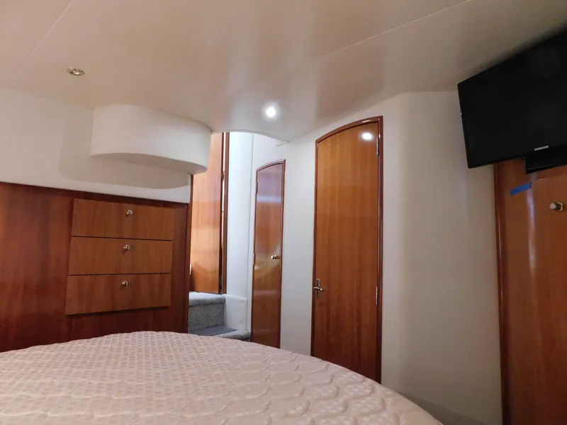 Slide: The Image of Interior of 2003 Carver 444 Cockpit Motor Yacht with wood paneling and TV. - 42