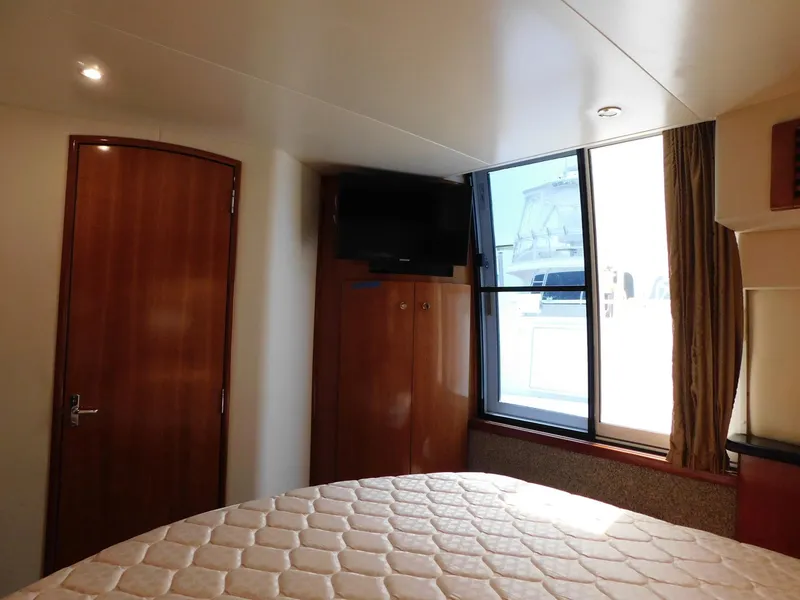 Slide: The Image of Interior of 2003 Carver 444 Cockpit Motor Yacht with bed, window, and TV. - 43