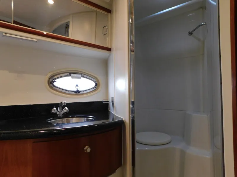 Slide: The Image of 2003 Carver 444 Cockpit Motor Yacht bathroom with sink, mirror, and shower. - 44
