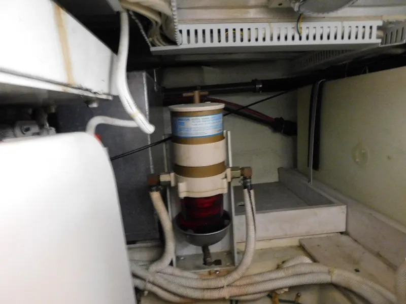 Slide: The Image of Engine compartment of 2003 Carver 444 Cockpit Motor Yacht with visible fuel filter system. - 47