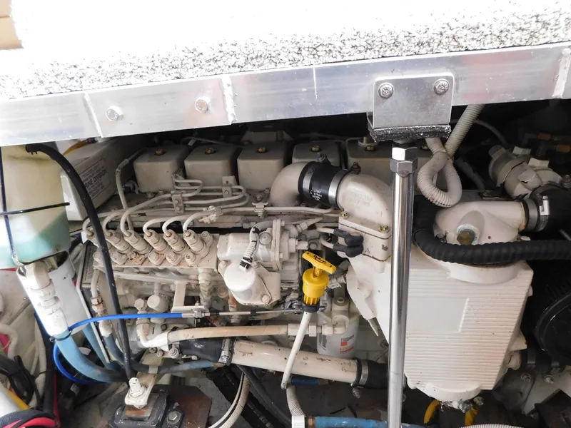 Slide: The Image of Engine compartment of a 2003 Carver 444 Cockpit Motor Yacht, showcasing mechanical components. - 48