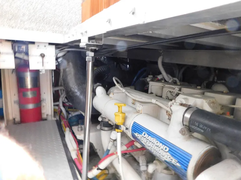 Slide: The Image of Engine room of a 2003 Carver 444 Cockpit Motor Yacht, showcasing mechanical components. - 49