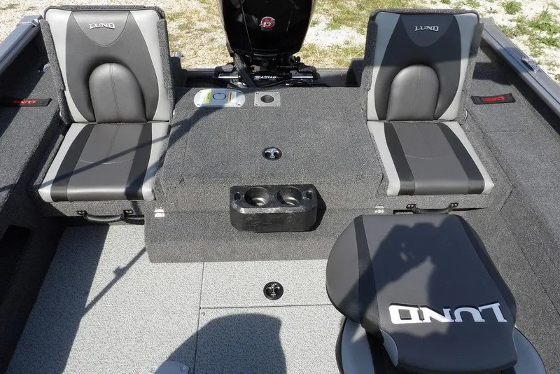 Slide: The Image of 2026 Lund 1875 Impact XS Sport boat interior with gray seating and cup holders. - 10