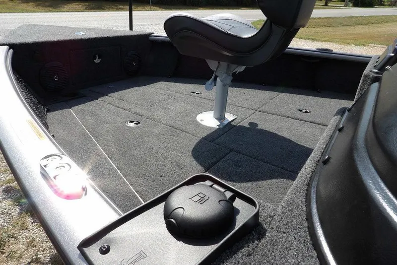 Slide: The Image of 2026 Lund 1875 Impact XS Sport boat interior with seating and carpeted deck. - 13