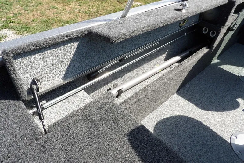 Slide: The Image of 2026 Lund 1875 Impact XS Sport boat interior storage compartment with carpeted finish. - 14