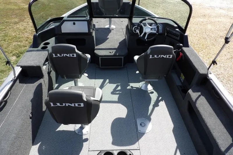 Slide: The Image of 2026 Lund 1875 Impact XS Sport boat interior with four seats and steering console. - 15