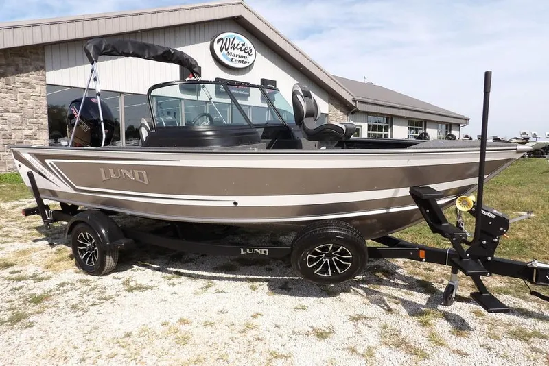 Slide: The Image of 2026 Lund 1875 Impact XS Sport boat on trailer outside marine center. - 4