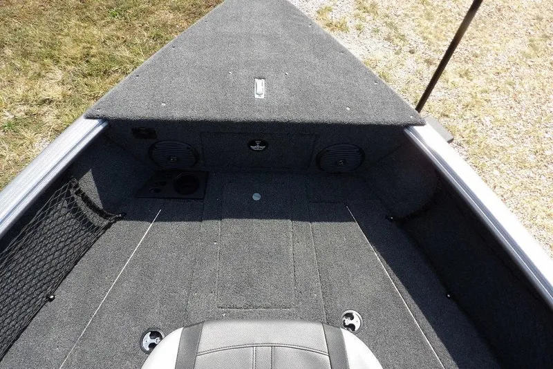 Slide: The Image of 2026 Lund 1875 Impact XS Sport boat interior with carpeted deck and storage compartments. - 41