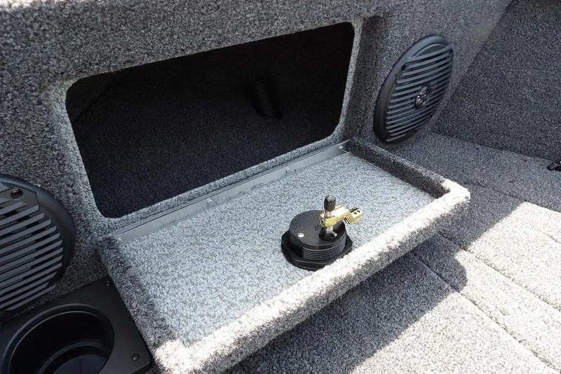 Slide: The Image of 2026 Lund 1875 Impact XS Sport boat interior with storage compartment and speaker. - 44