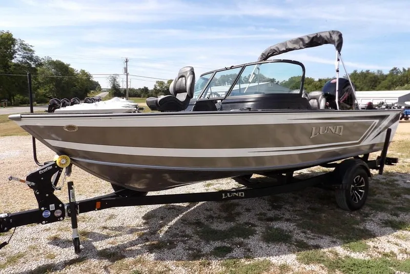 Slide: The Image of 2026 Lund 1875 Impact XS Sport boat on trailer, parked outdoors. - 5