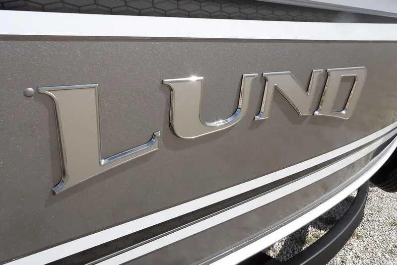 Slide: The Image of Close-up of 2026 Lund 1875 Impact XS Sport boat logo in chrome. - 50