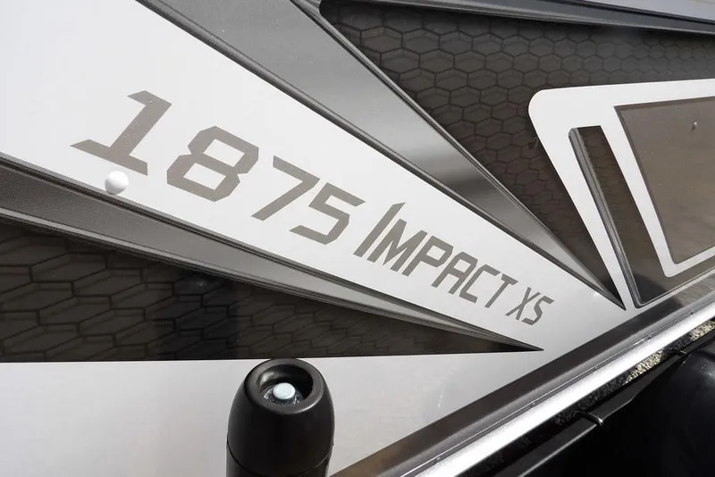 Slide: The Image of 2026 Lund 1875 Impact XS Sport boat logo with sleek design elements. - 51